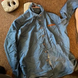 Blue button down long sleeve shirt.